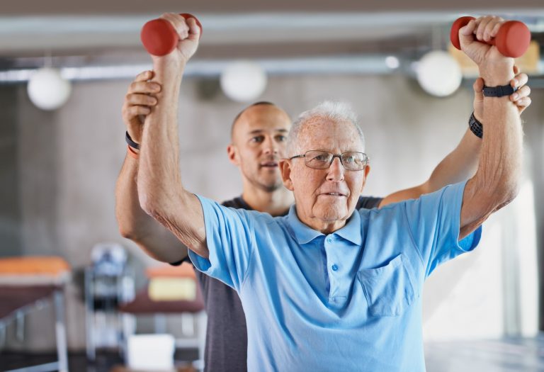 You can do it. Shot of a physiotherapist helping a senior man with weights